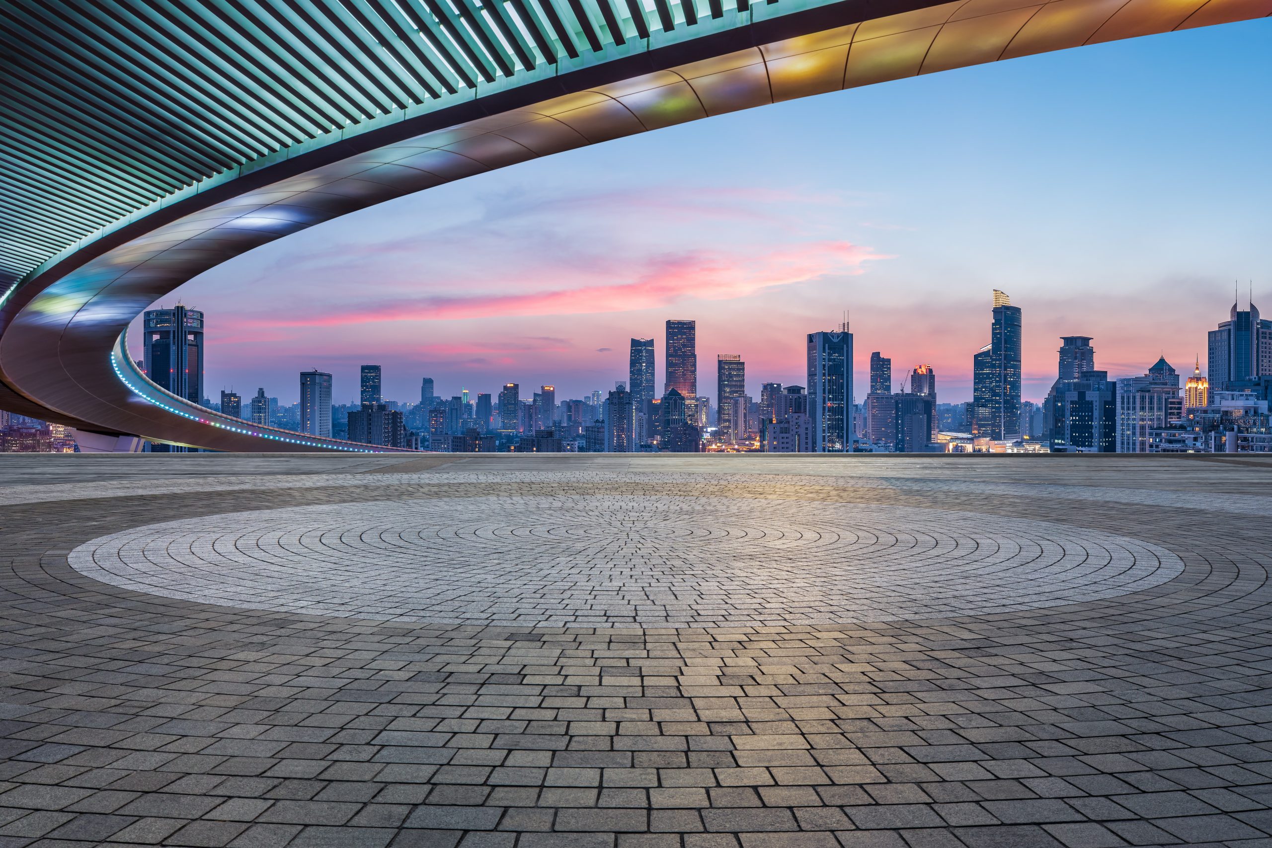 Empty square floors and bridge with city skyline at sunset in Sh