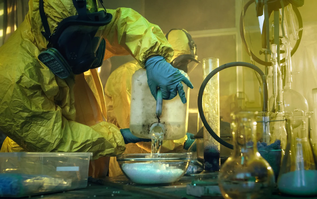 underground-drug-laboratory---two-clandestine-chemists-covered-in-protective-coveralls-and-gas-masks